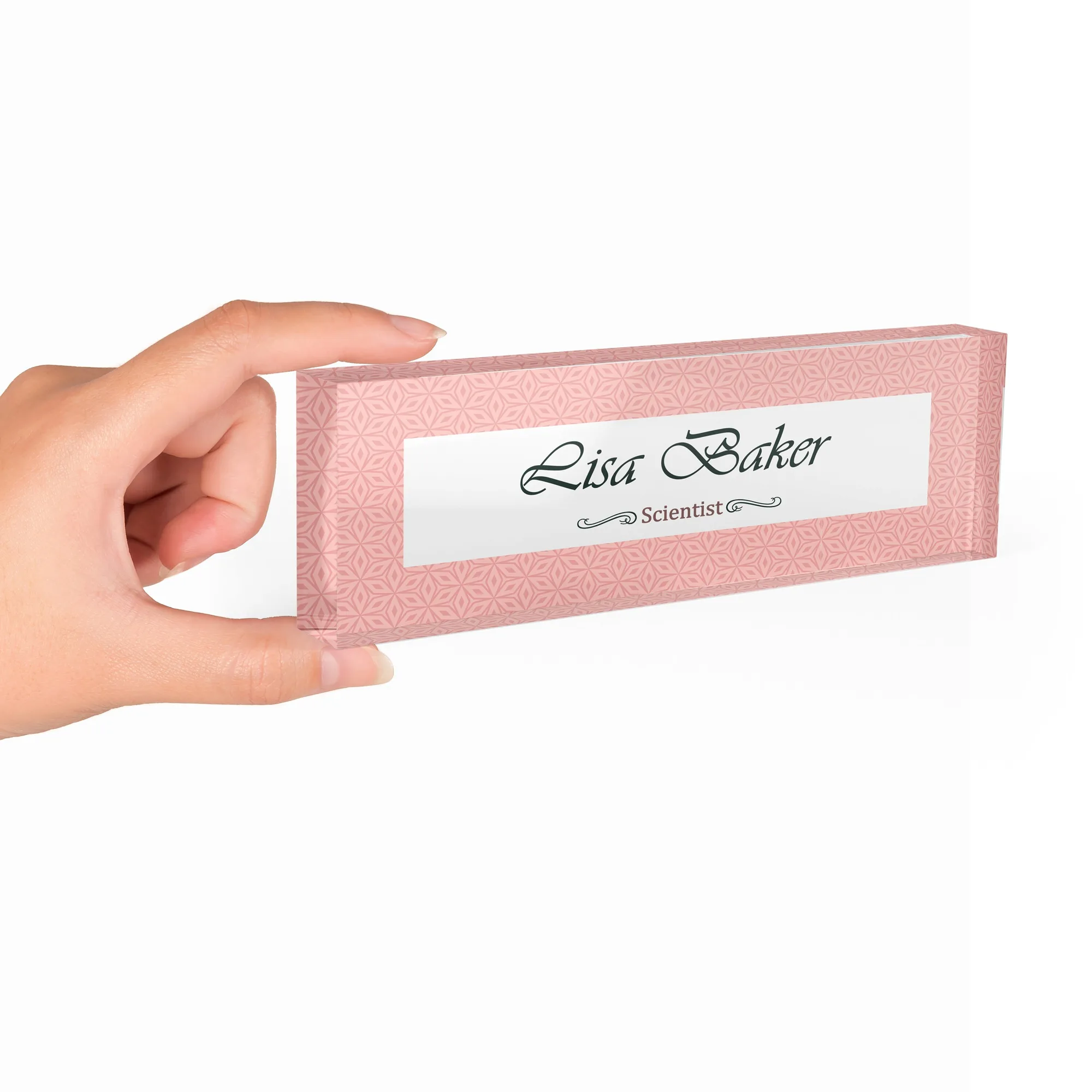 Hand holding a clear acrylic desk name plate with a blush pink textured design