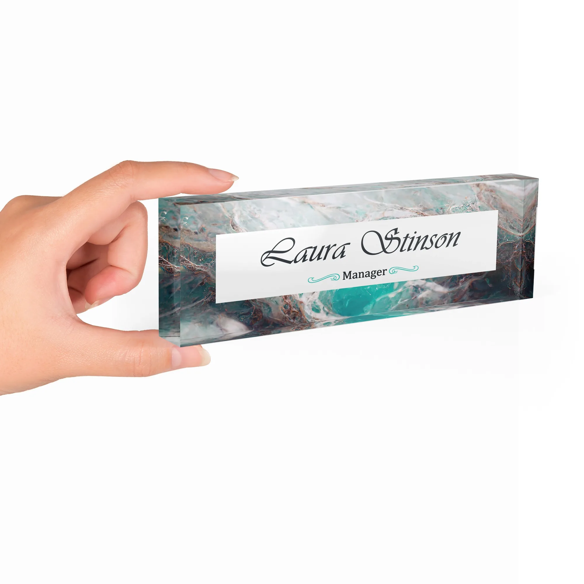 Hand holding a clear acrylic desk name plate with a turquoise marble design