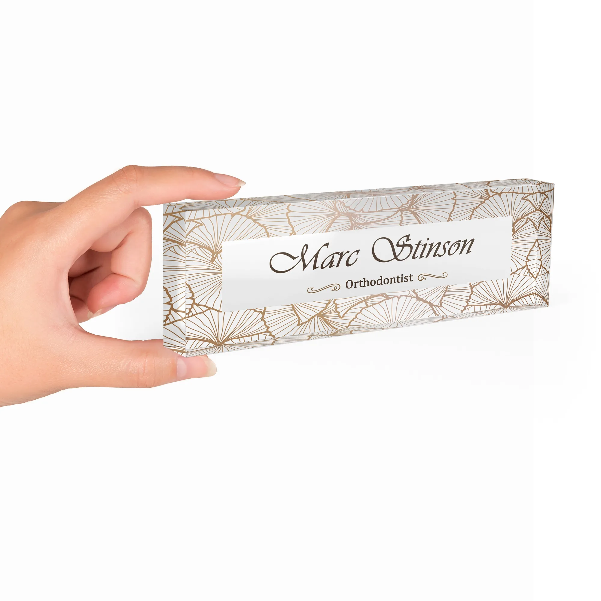 Hand holding a clear acrylic desk name plate with an art deco fan design