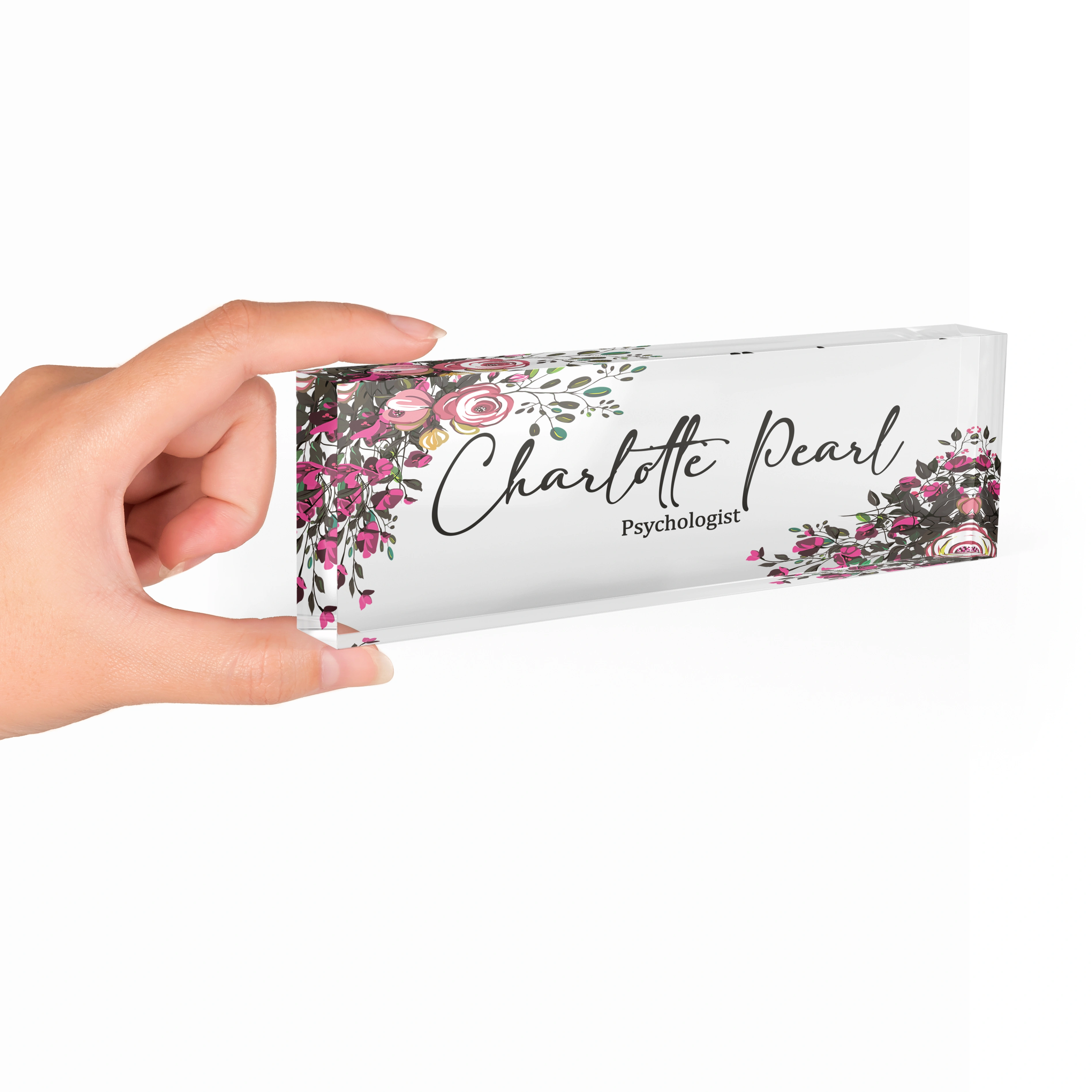 Hand holding a clear acrylic desk name plate with a burgundy rose design
