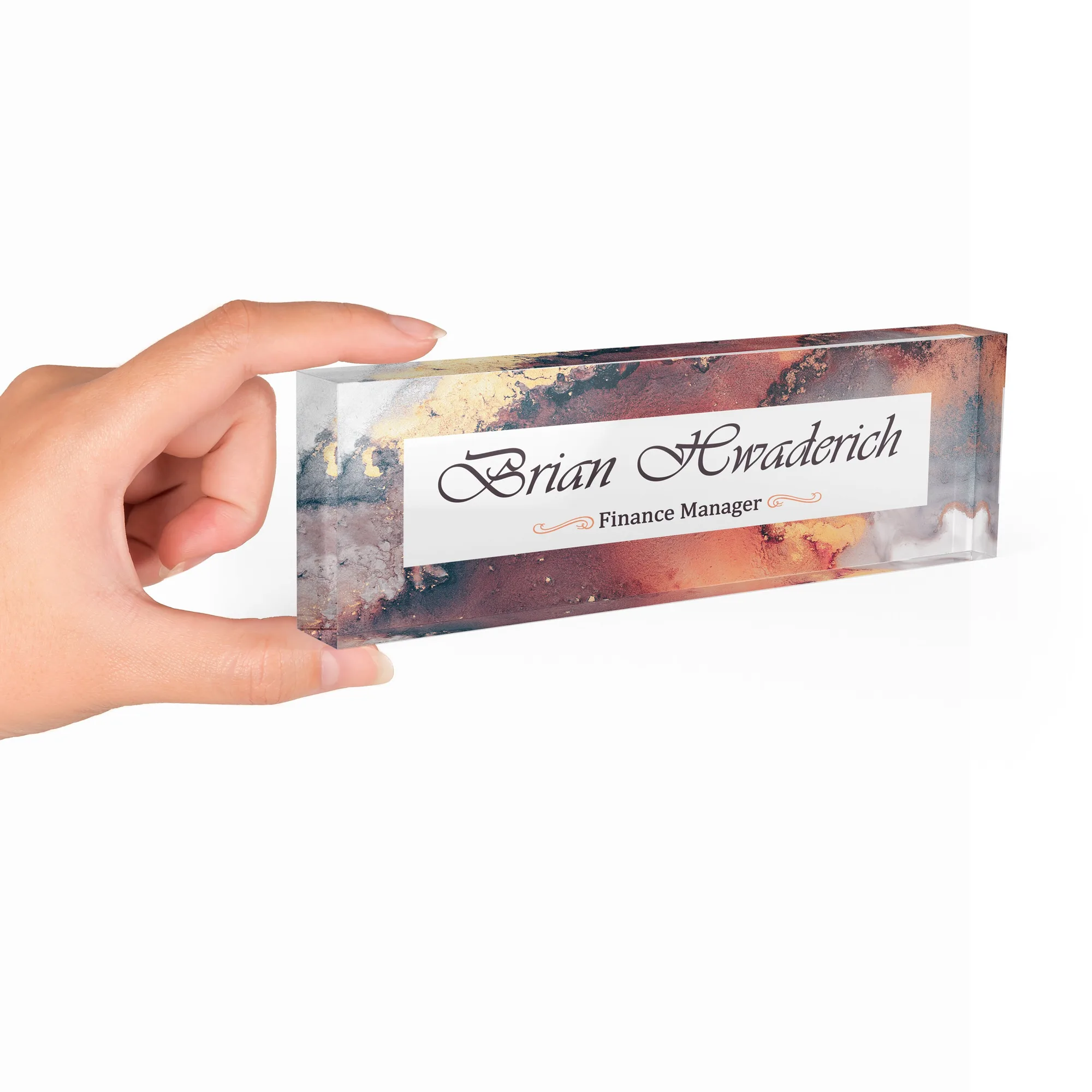 Hand holding a clear acrylic desk name plate with a burgundy and steel agate design