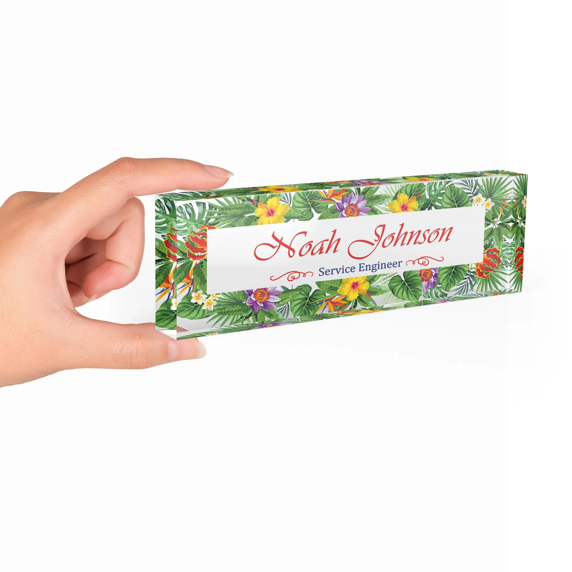 Hand holding a clear acrylic desk name plate with a tropical hibiscus design
