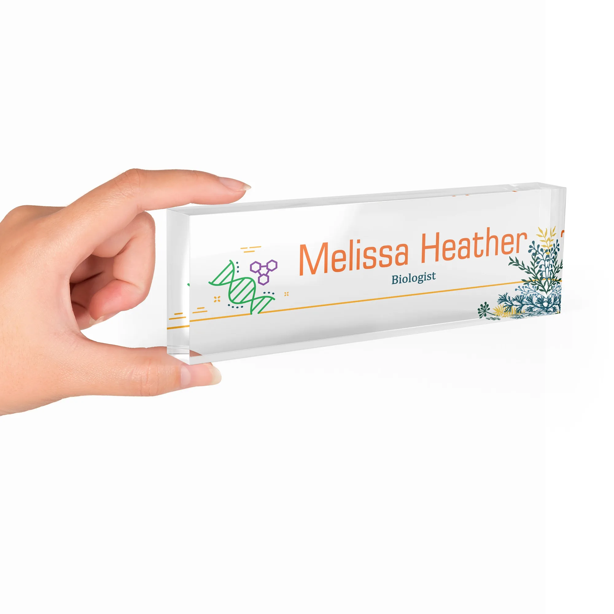 Hand holding a clear acrylic desk name plate with a DNA and botanical design