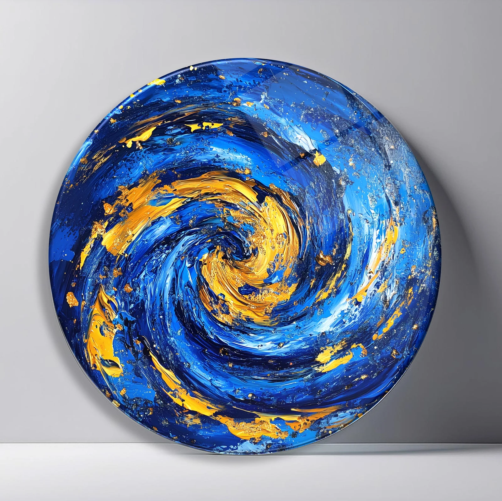 Blue Gold Cosmic Whirlpool Round Glass Wall Art featuring thick cobalt and gold paint strokes spiraling into a luminous vortex