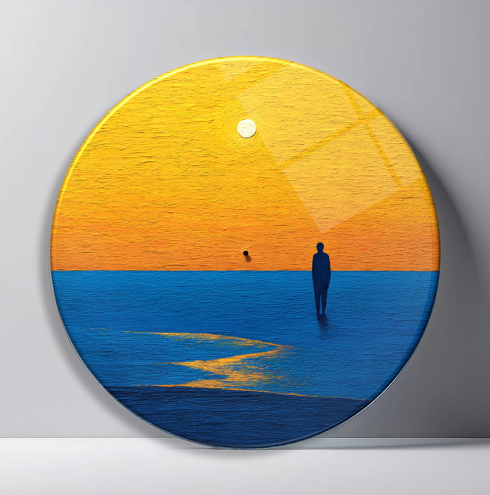 Solitary Figure at Golden Sunset Round Glass Wall Art featuring lone figure standing in blue water beneath a vast golden sky