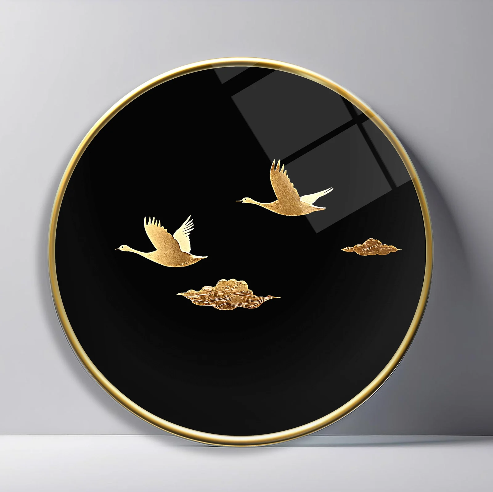 Golden Cranes and Clouds Round Glass Wall Art featuring pair of gold cranes gliding among stylized clouds on black