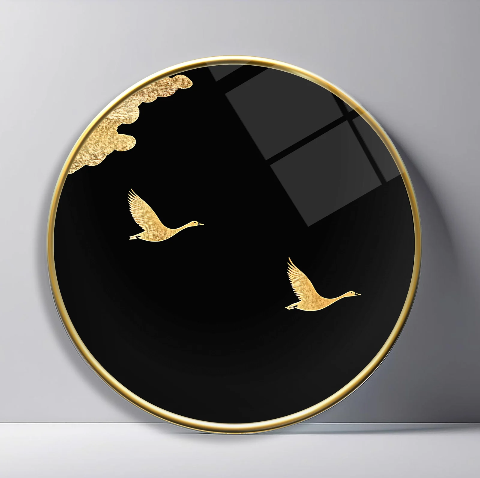 Golden Birds in Black Sky Round Glass Wall Art featuring two gold birds flying beneath a small cloud on a deep black field