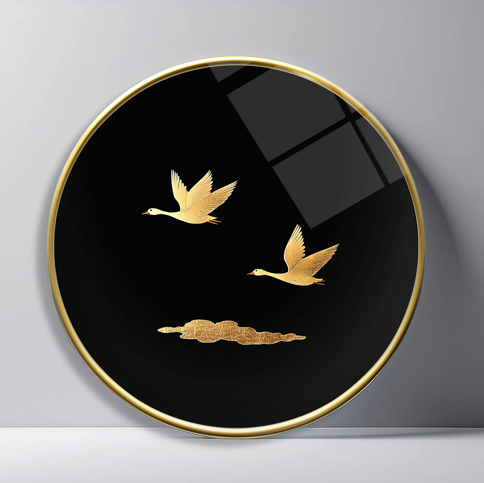Golden Cranes in Flight Round Glass Wall Art featuring two cranes crossing a black sky above a single gold cloud